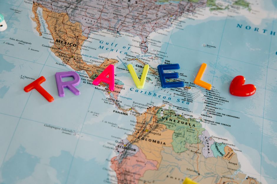 A clean, professional photo of house keys lying on top of a world map, illustrating the concept of unlocking your home's equity to fund travel and adventure.